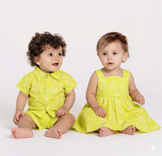 Two children wearing matching yellow outfits with geometric patterns on a white background